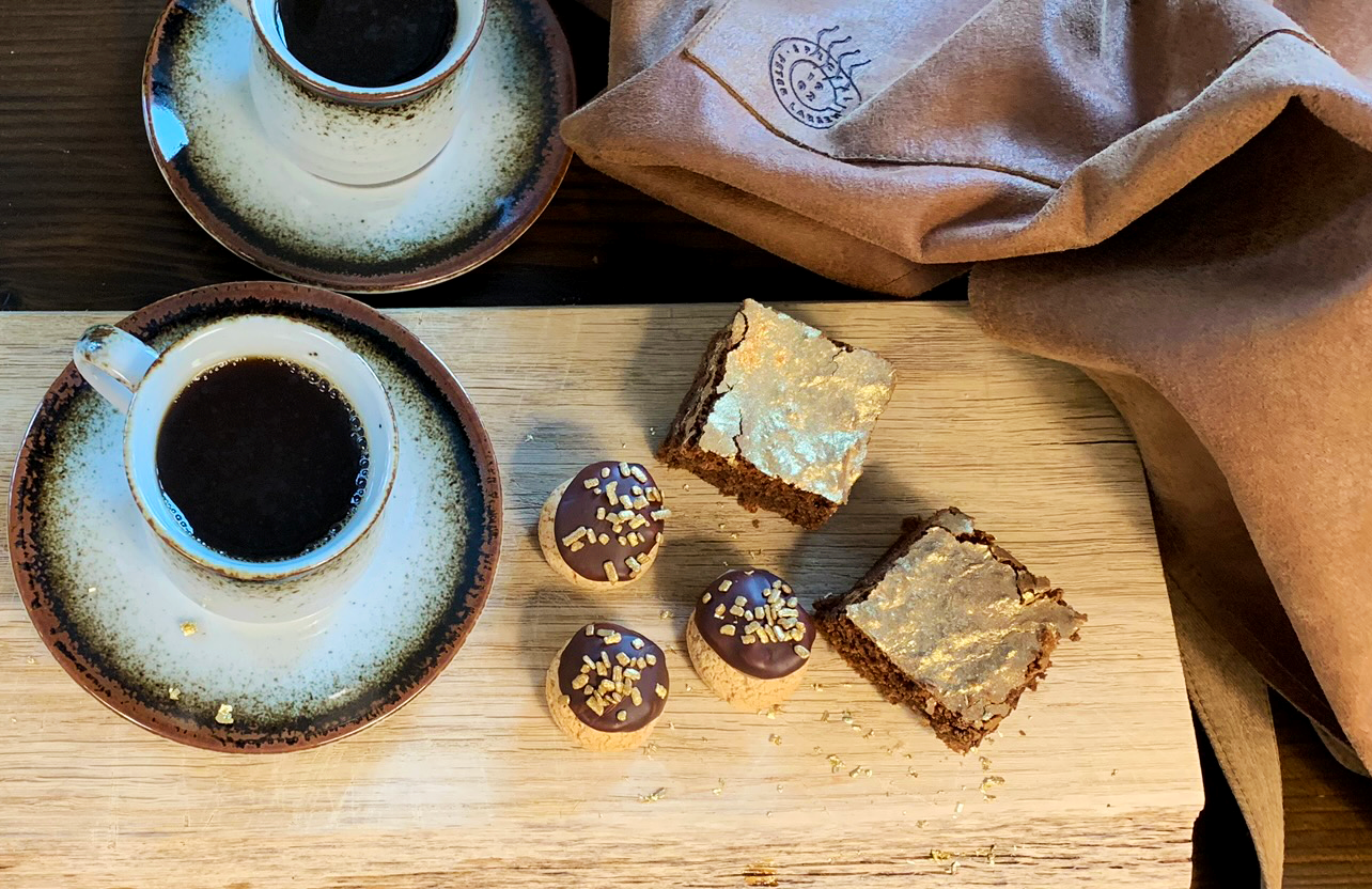 Et billede, der indeholder bord, kop, kaffe, træ, brownie